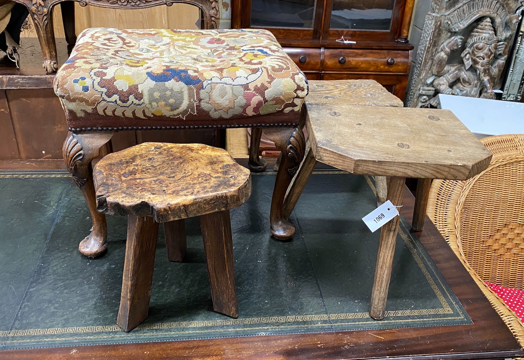 A George I style mahogany tapestry top dressing stool and three rustic stools